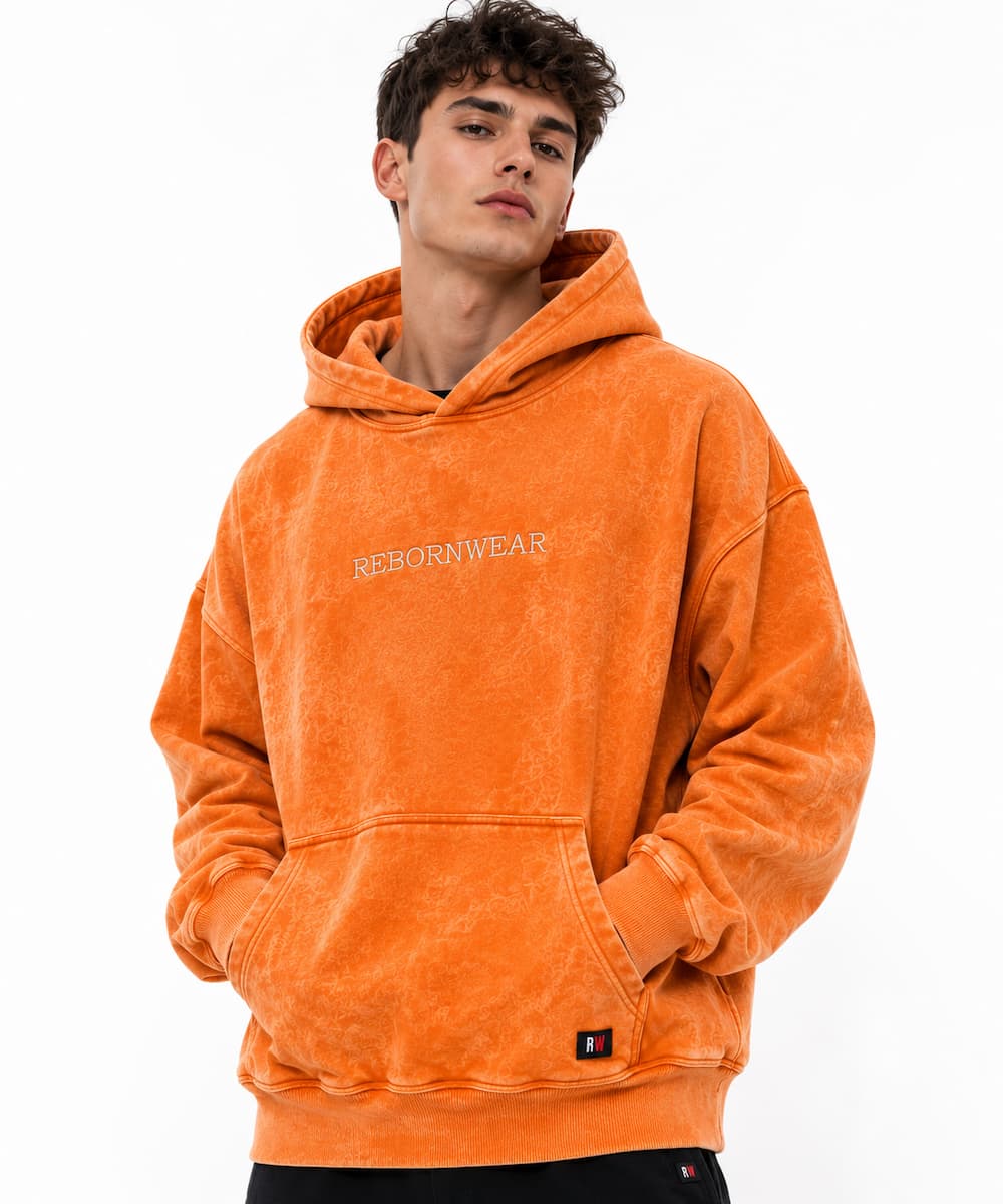 Custom men's hoodie in orange acid wash finish — private label manufacturer RebornWear, Sialkot Pakistan